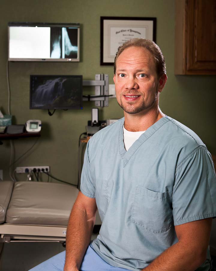 Dr. Frank Cherpack sitting wearing scrubs